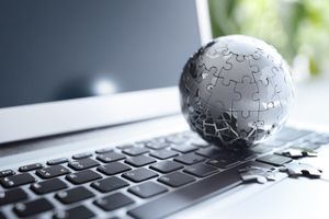 A puzzle-piece concept over a laptop, representing connected software systems.