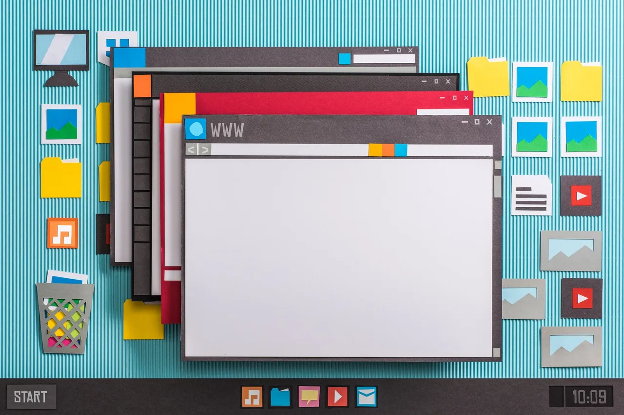 Paper cutout of a computer desktop screen with folders.